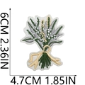 Detail showing embroidered green floral patch dimensions 6cm by 4.7cm with golden bow - Floral Arrangement