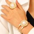 Adjustable gold spiral twisted ring and bracelet set with elegant pearl accents on model - Bracelet and Ring Set in Gold WG-1297
