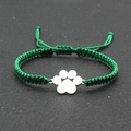 Close-up of green hand-woven adjustable bracelet with a silver dog paw print charm - Grass Green