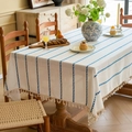 White rectangle tablecloth with blue vertical stripes and fringe on a wooden table - Blue and White Stripes