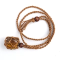 Detailed close-up of tiger eye stone pendant with brown handmade woven net and wooden beads - Tiger Eye