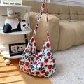 Detail of vintage canvas tote bag with red rose floral print on wooden floor - All-over Rose