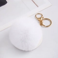 Macro detail of white faux fur pompom keychain with shiny gold lobster clasp hardware - White With Fur Ball