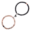 Macro detail of magnetic heart clasp on braided pink zebra stone couple bracelets - Agate and Matte Stone
