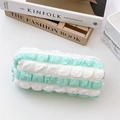 Detailed view of mint green striped pencil case with ruffled edges and smooth zipper - Spliced Green