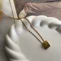Titanium steel necklace with gold-plated square pendant featuring an embossed letter S - S