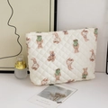 Detailed macro view of quilted makeup bag with cute cartoon bear and bunny patterns - Quilted Bear