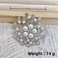 Silver star brooch featuring white pearls and rhinestones on a beige fabric stand - Silver Star Pearl Rhinestone