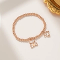 Roségouden kralenarmband met dubbele vlinderhangers en witte schelpinleg afwerking - Roségoud