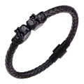 Detail of black braided leather bracelet featuring metal skulls and magnetic clasp - Black/Black