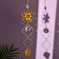 Detail of sun catcher featuring golden flower, crystal ball, and natural amber stone - Tiger Eye Stone Bracelet