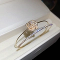Detailed macro of golden double-layer zircon flower ring in a velvet jewelry box - Gold