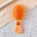 Compact orange air cushion hairbrush featuring a cute pumpkin character handle - Pumpkin (Long Comb)