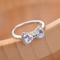 Silver bow ring with sparkling triangle gemstones and pavé accents in a classic design - Bow Ring Ljz-213 / Adjustable Open