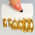Detailed macro view of three pairs of gold-plated geometric hoop earrings set on a card - 13 KC Gold (2987)