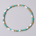 Minimalist beaded bracelet featuring a mix of white, turquoise, and golden seed beads - Turquoise White Gold