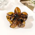 Detail of amber translucent floral hair claw clip made of resin with metal spring - Amber Coffee Yellow