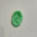 Green oval plush BB hair clip with soft faux fur texture for women on leather background - Green