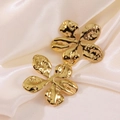 Elegant gold flower stud earrings with hammered texture on cream silk fabric - Gold