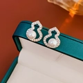 Detailed view of silver gourd-shaped earrings with pearls and zircons in a green box - Gourd Pearl Stud Earrings (Silver Earring Post)