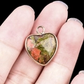 Heart-shaped green and red natural stone pendant with a polished golden metal edge - Unakite Gold Edging