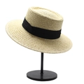 Detailed weave of natural straw boater hat with black ribbon on minimalist metal stand - Beige + Black Ribbon