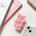 Dettaglio di un supporto per cellulare a forma di orso 3D con glitter olografici - Rosa (Glitter Laser)