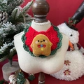 Detail of red and green crochet pet scarf featuring a cute gingerbread man character - One Size / Christmas Gingerbread Man