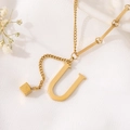 Detailed macro view of a gold U-shaped pendant with an elegant mixed link chain design - Gold Initial U (8847)