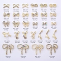 Macro display of bowknot nail charms set with pearls and rhinestones in various sizes - White Rhinestone Bowknot (AA52) / Gold