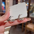 Silver hoop earrings with a textured lava finish on a white jewelry card holder - Irregular Lava Texture Hoop / Silver