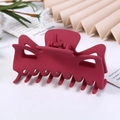 Close-up of a large wine red matte hair claw clip with a hollow geometric design - Frosted Red / 9.5CM