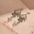 Close-up of bohemian earrings with butterfly charms, mint beads and long metal tassels - Green Bead Butterfly Tassel Style (Silver Needle)