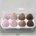 Detailed view of 8 soft makeup sponges in a neat storage box with white slots - 8-Piece Set - Avocado Green (Green Series)