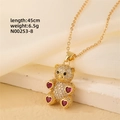 Detail shot of a gold teddy bear pendant with white zircons and red heart gems - Gold - Red Hearts Limbs Bear