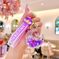Detailed close-up of a crescent unicorn quicksand keychain with purple wrist strap - Purple Colorful Bead Star Moon Rabbit