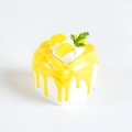Miniature square cake fridge magnet with yellow icing, cream flower and fruit slice decoration - Mango Yellow
