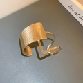 Detailed view of irregular hammered texture on a polished gold-plated open cuff bracelet - Gold Hammered Irregular Design Style