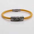 Detail of yellow braided leather bracelet with silver magnetic clasp and cross charm - Platinum P