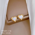 Macro detail of heart-shaped clover stud earrings with white shell inlay in gold frame - Titanium Steel / Heart Shell (T133)
