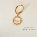 Detail view of 14K gold hoop earring featuring mother of pearl sun and moon pendant charms - Moon Sun Shell