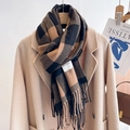 Close-up of brown plaid scarf with tassels and Self Service label on beige coat - Large Plaid Black Coffee