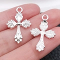 Silver cross pendants for DIY jewelry making shown in hand with metallic finish - 26x16mm (1.2g)