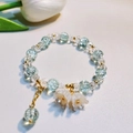 Elegant beaded bracelet featuring light blue and clear beads with golden flower charms - S017-light Blue Lily Of The Valley Bracelet #sz184