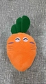 Plush carrot dog toy with squeaky feature, orange fabric and smiling embroidery - Carrot
