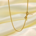 Elegant gold bow snake chain necklace for women made of 18K gold plated titanium steel - Bowknot Necklace / Gold