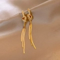 Macro shot of gold tassel earrings with zircon knots on elegant champagne satin fabric - Gold Snake Bone Chain Long Tassel Earrings