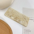 Beige marble pattern acetate wide tooth comb with vintage aesthetic on a tray - Off White