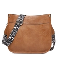 Brown leather saddle crossbody bag featuring a bold leopard print wide shoulder strap - Brown