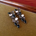 Close-up of gold-plated leaf earrings with black and clear crystals on green fabric - 23# Silver Earring Post - Black - Leaf